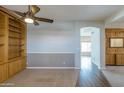 Living room featuring hardwood and carpet flooring with a built in bookshelf at 1249 W Seascape Dr, Gilbert, AZ 85233