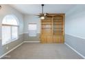 This living room features a large arched window, wainscotting, and a built-in bookcase at 1249 W Seascape Dr, Gilbert, AZ 85233