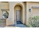 Welcoming front door with an arched entryway and desert landscaping at 1322 S 118Th Dr, Avondale, AZ 85323