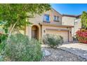 Attractive home with desert landscaping, an arched entryway, and a two-car garage at 1322 S 118Th Dr, Avondale, AZ 85323