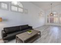 Bright, open living room with wood flooring, modern lighting, and stylish shutters at 1331 E Voltaire Ave, Phoenix, AZ 85022