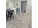 A modern dining room features laminate flooring, neutral walls, and is adjacent to the front entry at 13636 W Antelope Dr, Sun City West, AZ 85375