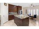 Modern kitchen with wood cabinets, granite countertops, and stainless steel appliances at 14010 N 12Th St, Phoenix, AZ 85022