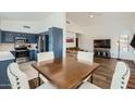 Eat-in kitchen featuring navy cabinets, stainless steel appliances, and modern finishes at 14300 W Bell Rd # 307, Surprise, AZ 85374