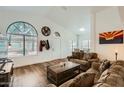 Inviting living room with wood floors, high ceilings, large windows, and comfortable seating at 14300 W Bell Rd # 307, Surprise, AZ 85374