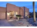 Attractive single-story home with desert-friendly landscaping, a stone accent wall, and a welcoming entrance at 17234 E Sunscape Dr, Fountain Hills, AZ 85268