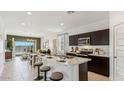 Modern kitchen features dark cabinetry, a marble countertop island, and stainless steel appliances at 1773 W Sombra Ave, Apache Junction, AZ 85120