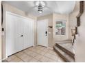 Spacious foyer with tiled floor, a coat closet, and stairs leading to the upper level at 1928 E 39Th Ave, Apache Junction, AZ 85119