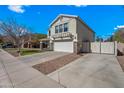 This home includes stone accents, a two-car garage and a well-maintained front yard at 1928 E 39Th Ave, Apache Junction, AZ 85119