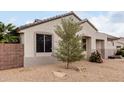 Manicured front yard features desert landscaping, decorative rocks, and a small accent tree at 20319 N Painted Sky Dr, Surprise, AZ 85374