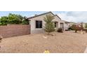 Well-maintained desert landscaping surrounds the home, complemented by a small decorative tree at 20319 N Painted Sky Dr, Surprise, AZ 85374