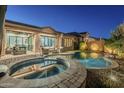 Beautiful backyard pool and spa area with outdoor seating and lush foliage at 2113 N Trowbridge St, Mesa, AZ 85207