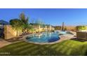 Sparkling pool and spa surrounded by lush landscaping and privacy fence at 2113 N Trowbridge St, Mesa, AZ 85207