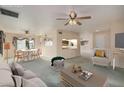 Bright living room featuring a ceiling fan, view to the dining area, and neutral decor at 2327 W Rockwell Ct, Chandler, AZ 85224