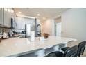 Contemporary kitchen featuring a spacious breakfast bar, stainless steel appliances, and ample cabinet space at 2511 W Queen Creek Rd # 479, Chandler, AZ 85248