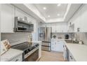Bright kitchen with stainless steel refrigerator and appliances, white cabinetry, and quartz countertops at 3102 E Clarendon Ave # 210, Phoenix, AZ 85016