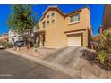 A two-story home shows desert landscaping, driveway to attached garage in a residential area at 335 S Travis --, Mesa, AZ 85208