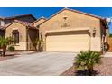 Home exterior features desert landscaping, a tile roof, and a two-car garage at 346 E Red Mesa Trl, San Tan Valley, AZ 85143