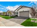 Attractive home featuring manicured landscaping, a brick driveway, and a two-car garage at 3483 E Bloomfield Pkwy, Gilbert, AZ 85296