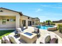 Entertainer's backyard with a fire pit, seating, desert landscaping, and sparkling pool and spa at 35348 N 87Th St, Scottsdale, AZ 85266