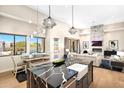 Modern kitchen featuring a black island countertop and sink with a combined living and dining area at 35348 N 87Th St, Scottsdale, AZ 85266