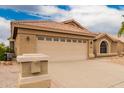 Home exterior features a two-car garage, desert landscaping, and a tile roof at 3690 N 150Th Ave, Goodyear, AZ 85395