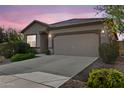 Attractive single-story home with a wide driveway, attached two-car garage, and well-maintained landscaping at 393 S Soledad Ln, Casa Grande, AZ 85194