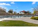 Inviting community pool area with shade structures, ample seating, and meticulously kept landscaping at 393 S Soledad Ln, Casa Grande, AZ 85194
