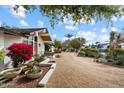 Spacious front yard featuring desert landscaping and a long driveway leading to the home at 4010 E Montebello Ave, Phoenix, AZ 85018