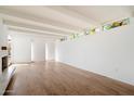 Bright, airy living room with hardwood floors, modern lighting, and stained glass accents at 4010 E Montebello Ave, Phoenix, AZ 85018