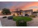 Beautiful single-story house with landscaped front yard, lush green lawn, and desert landscaping at 4614 W Fallen Leaf Ln, Glendale, AZ 85310