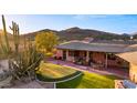 Backyard featuring a putting green, patio and beautiful views of desert and hills at 5480 E Desert Creek Ln, Cave Creek, AZ 85331