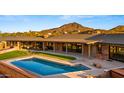 Private backyard oasis with a refreshing pool and manicured lawn space at 5480 E Desert Creek Ln, Cave Creek, AZ 85331