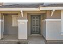 Close up of the gray front door with sidelights and the house number visible at 5828 E Hampton Ave, Mesa, AZ 85206
