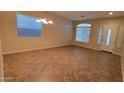 Open living room with natural light, tile flooring, and archway at 10382 W Cashman Dr, Peoria, AZ 85383