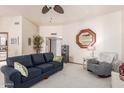 Cozy living room with plush seating, ceiling fan, and a neutral color palette at 10510 W Palmeras Dr, Sun City, AZ 85373