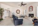 Comfortable living room boasts a cozy fireplace and neutral decor, perfect for relaxing at 10510 W Palmeras Dr, Sun City, AZ 85373