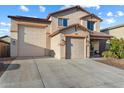 Two-story stucco home featuring a three car garage and covered entry at 12132 W Daley Ln, Sun City, AZ 85373