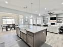 Gourmet kitchen island with seating and a farmhouse sink, open to the living space at 12204 W Black Hawk Rd, Casa Grande, AZ 85194