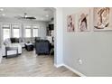 Inviting living room featuring a large sectional, ceiling fan, and stylish decor at 12204 W Black Hawk Rd, Casa Grande, AZ 85194
