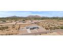 Bird's-eye view of a modern home in a desert landscape with stunning mountain views at 12204 W Blackhawk Rd, Casa Grande, AZ 85194