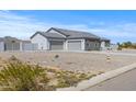 Contemporary home with desert landscaping, and a three car garage, with a fire hydrant in front at 12204 W Blackhawk Rd, Casa Grande, AZ 85194