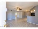 Bright living room featuring tile flooring, ceiling fan, neutral walls and open space at 16402 N 31 St # 122, Phoenix, AZ 85032