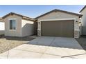 Attractive one-story home with a two-car garage, long driveway, and low maintenance desert landscaping at 17165 W Corrine Dr, Surprise, AZ 85388