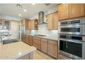 Modern kitchen with stainless steel appliances and stylish tile backsplash at 1804 E Amaranth Trl, Queen Creek, AZ 85140