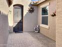 Inviting front entrance featuring a decorative security door and a charming tiled patio at 19765 N Swan Ct, Maricopa, AZ 85138