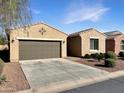 Charming single-story home featuring a well-maintained front yard and a convenient two-car garage at 19765 N Swan Ct, Maricopa, AZ 85138