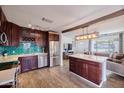 Modern kitchen with a center island, stainless steel appliances, and cabinetry, and a view to the living area at 2002 E Mitchell Dr, Phoenix, AZ 85016