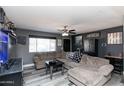 Comfortable living room with a large sectional sofa, modern ceiling fan, and stylish decor at 2061 E Bayberry Ave, Mesa, AZ 85204