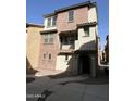 Charming two-story townhouse with a balcony and a well-maintained walkway at 2107 N 77Th Dr, Phoenix, AZ 85035